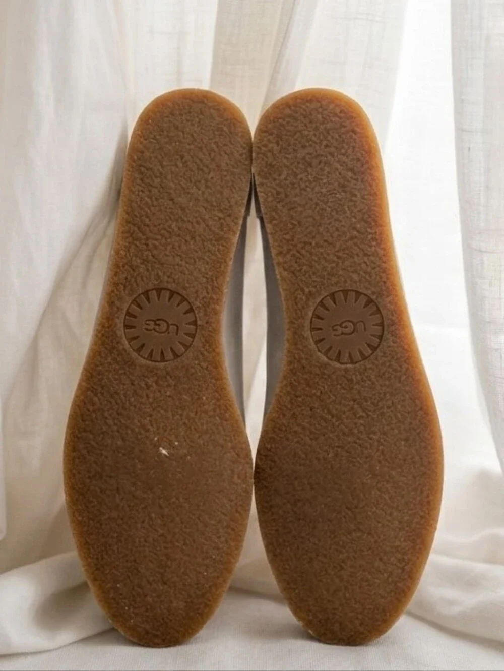 UGG Vista slip-on flats featuring a distinct scalloped edge detail.